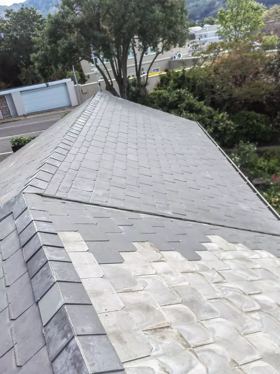 Grey slate roof showing weathered and repaired sections